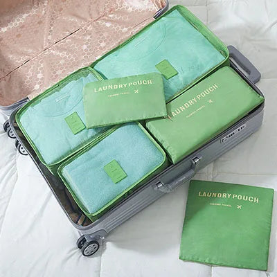 A gray storage organizer set containing six light green laundry pouches for clothes.