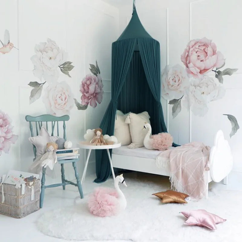 A pink princess canopy mosquito net for kids decorated with floral accents and soft pink and white textures.