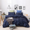 A navy blue duvet cover set featuring a starry sky pattern displayed on a bed in a bright room.