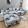 L-shaped sofa protector covers featuring a white and navy botanical print on a gray wall.