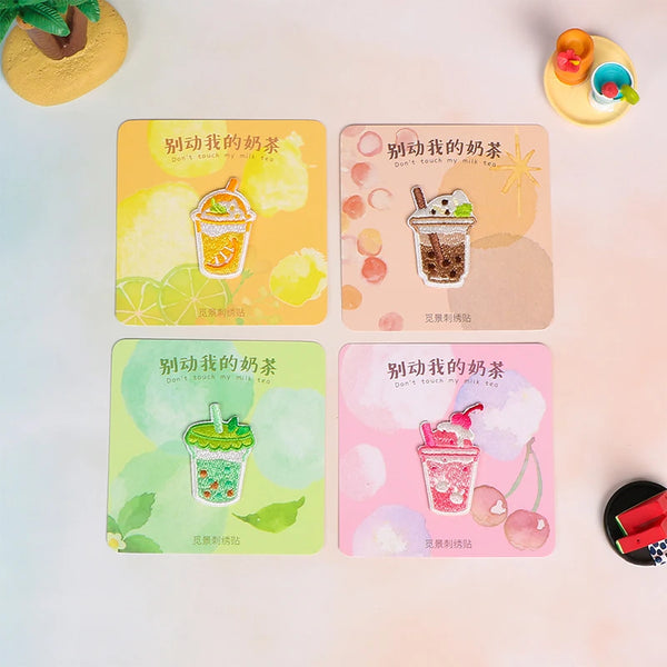 A collection of five yellow, green, and pink iron-on embroidered patches featuring illustrations of various drinks and food i