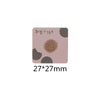 A square patch featuring a round, textured brown food or drink design on a light pink background.