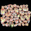 A collection of pink and iridescent silver claw rhinestones arranged in a decorative pattern.