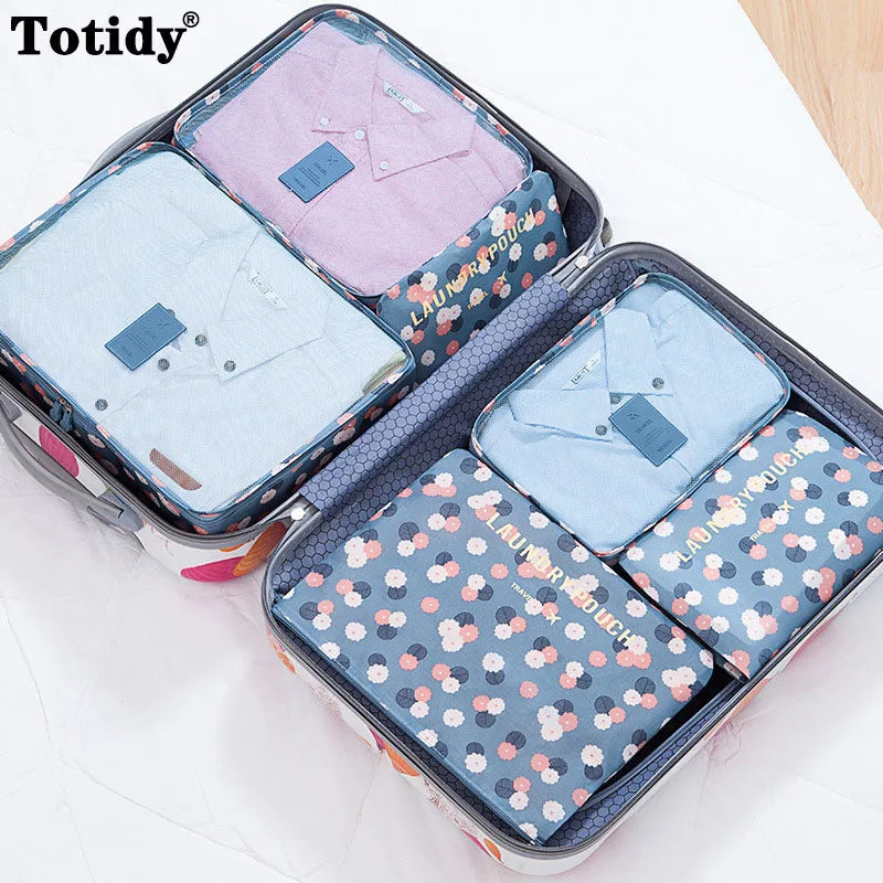 A storage organizer set containing six folded light blue and pink shirts in a zippered case.