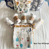 A collection of various patterned cotton muslin swaddle blankets displayed on a white surface.