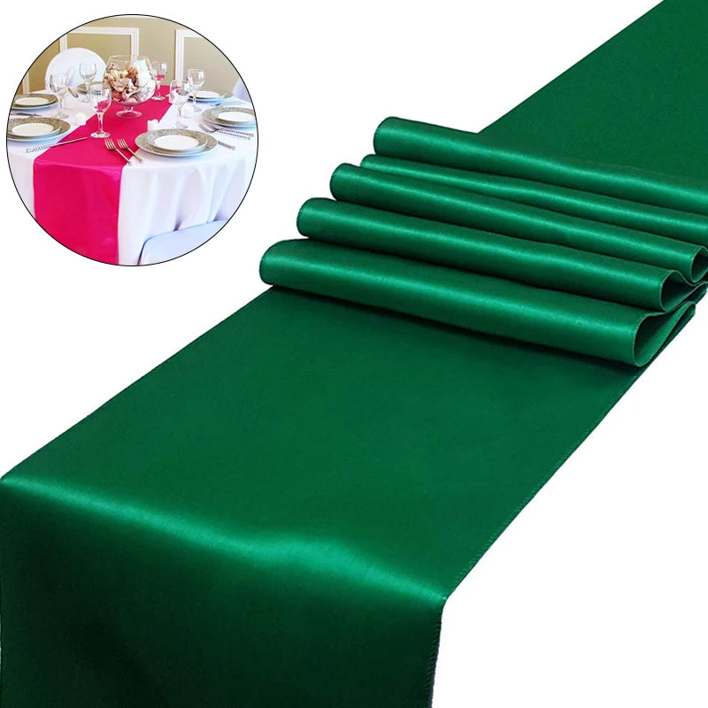 Emerald green satin table runner with rolled edges and a small inset showing a decorated dining table.