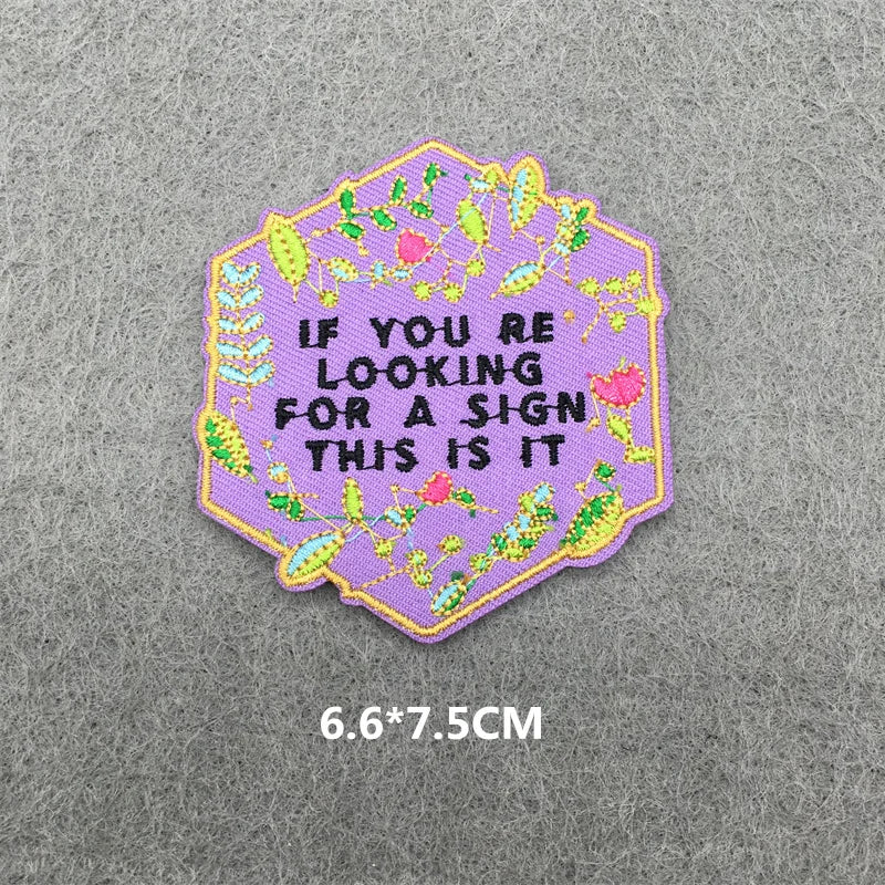A pink and green embroidered iron-on patch with the text If you are looking for a sign this is it