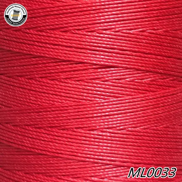 A spool of bright red embroidery thread with a white label and the product code ML0033.