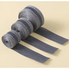 Rolls of gray self-adhesive hem tape for fabric repair and shortening displayed on a light background.