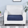 A white armchair with a dark blue stretchable fleece seat cushion cover placed on the seat.