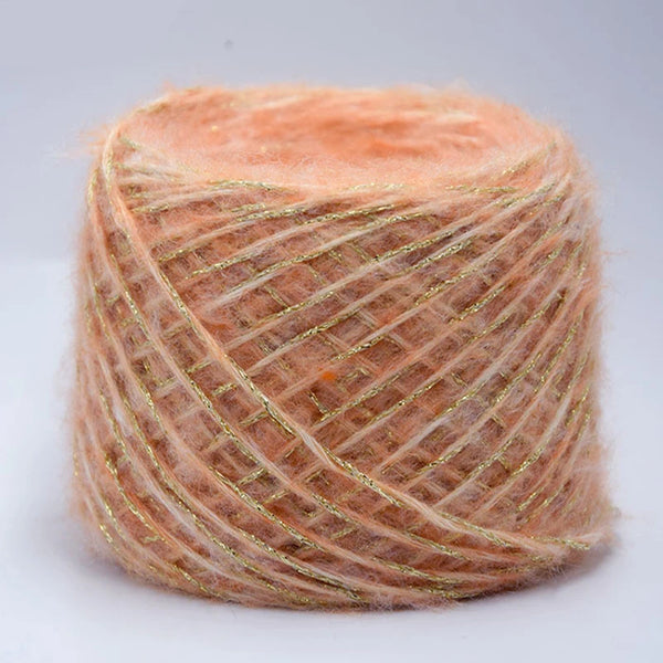 Spool of metallic orange merino wool yarn used for hand knitting
