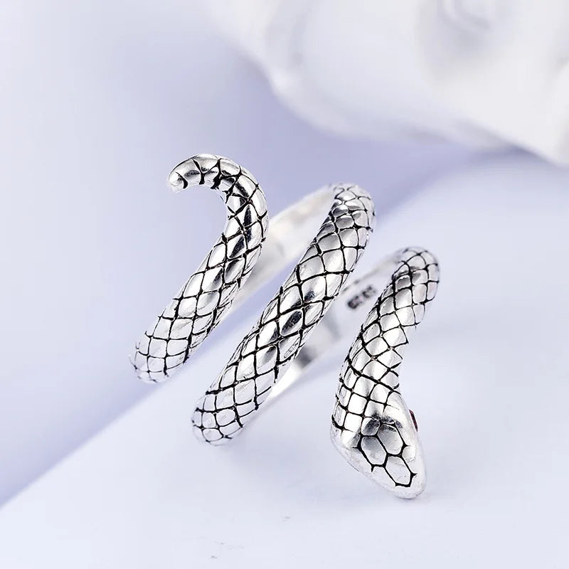 Silver animal-shaped finger rings with a textured, scale pattern displayed on a white background.