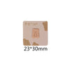 A square beige iron-on patch featuring a light brown, fluffy bear embroidery.
