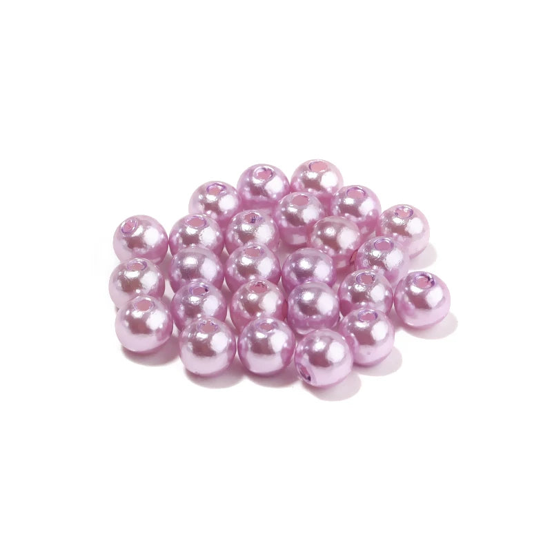 A pile of pink imitation pearl beads for DIY jewelry making