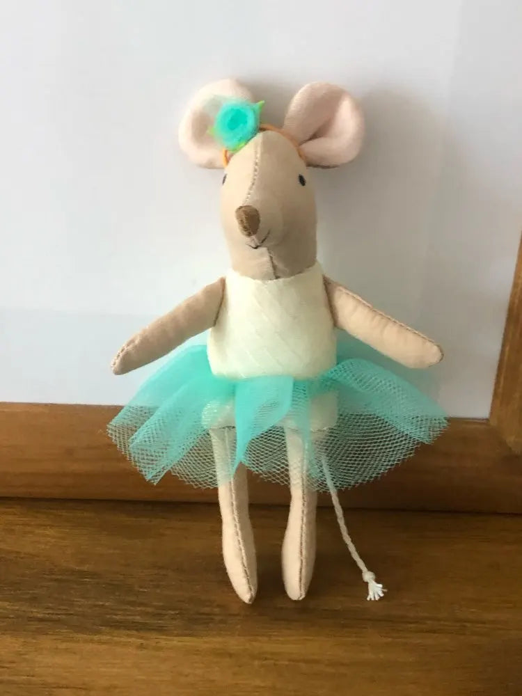 A handmade cotton toy filler batting shaped like a small brown rabbit with light tan ears and a turquoise tutu skirt.