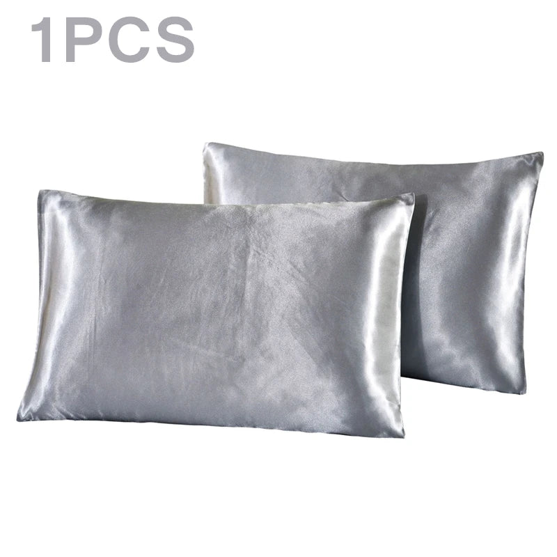 One silky satin pillowcase in a light silver color.
