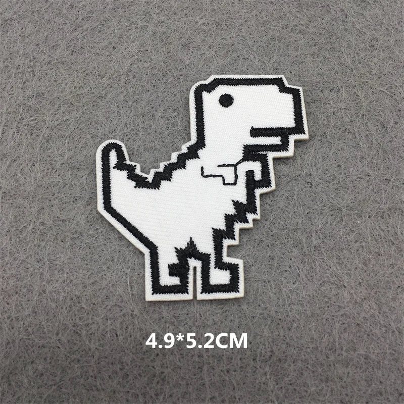 A white embroidered patch of a dinosaur silhouette on a gray fabric background.