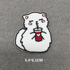 A white cat embroidered patch with pink accents, holding a red cup.