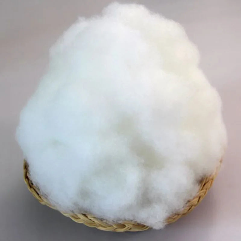 A fluffy white ball of handmade cotton toy filler batting for crafting.