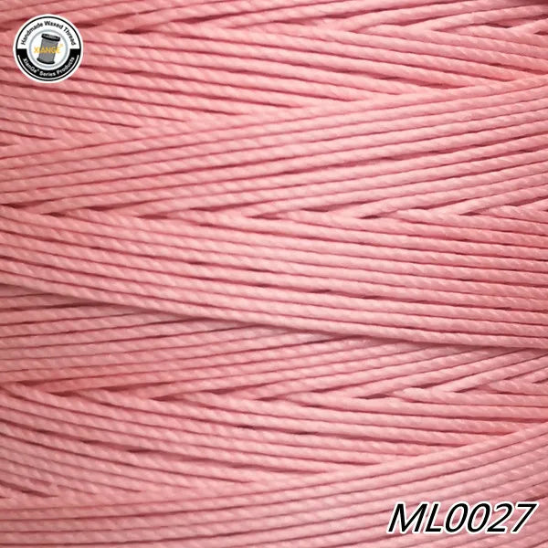 Pink waxed thread embroidery cord in a spool view