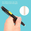 A hand holds a black pen with a yellow tip, demonstrating how the pen shell protects wax strip from damage.