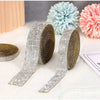Silver and gold diamond rhinestone strips for DIY decor displayed next to fluffy pom-pom flowers
