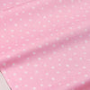 Pink floral and stripe cotton twill fabric rolled up, showing a light pink background with small white flowers.