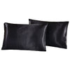 Black silky satin pillowcases stacked together.