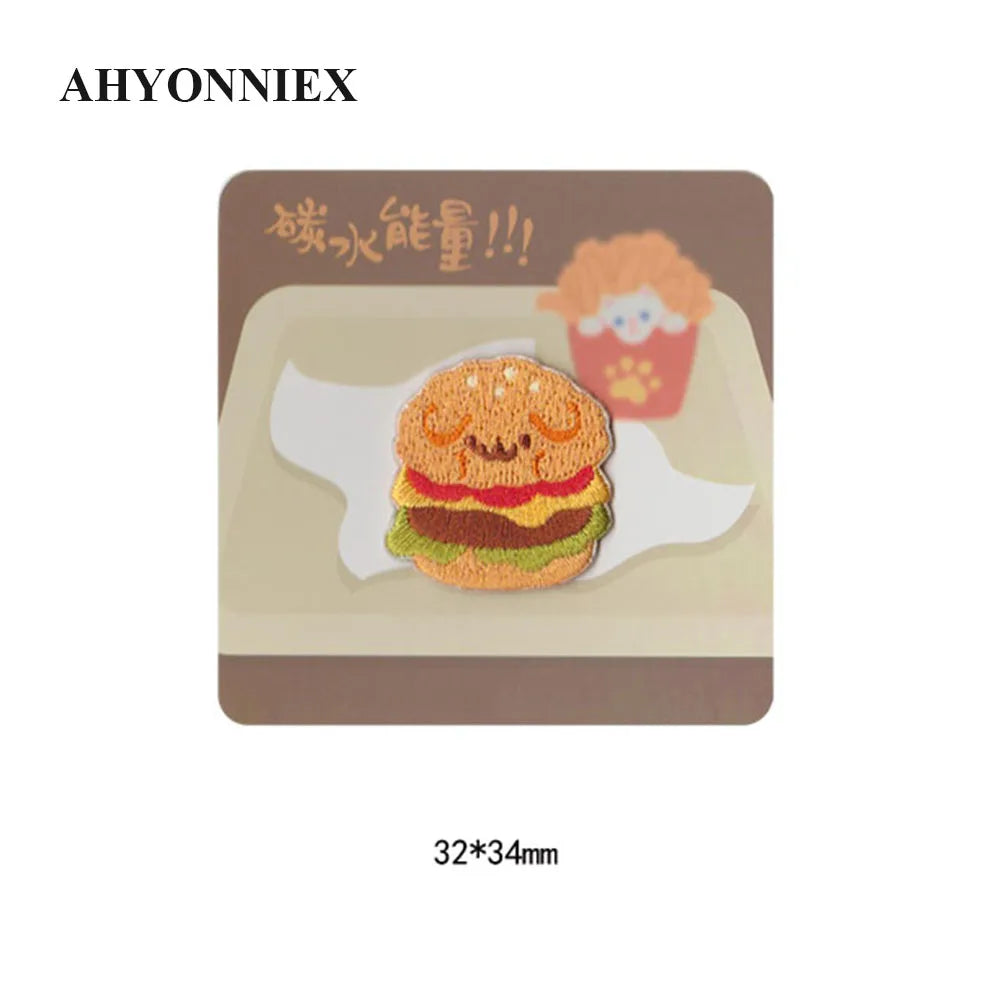 A square patch featuring an embroidered hamburger and a cup, with Chinese text above it.