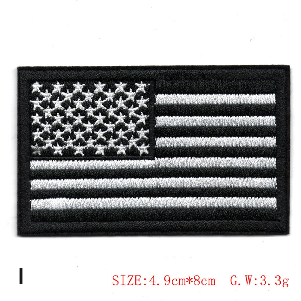 Black embroidered patch featuring the design of the American flag with white stars and stripes