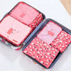 A set of six pink fabric storage organizers for clothes, arranged in a rectangular box.