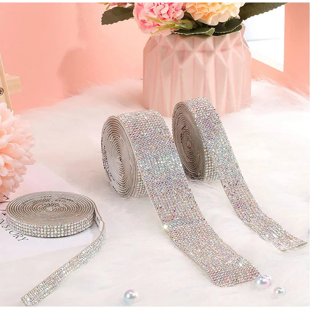 Silver diamond rhinestone strips for DIY decor displayed on a white fluffy surface.