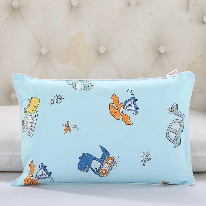 Light blue cartoon style children's pillowcase featuring dinosaur and vehicle designs