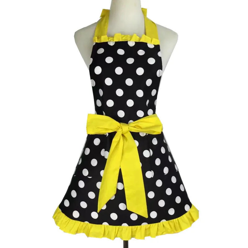 A yellow polka dot ruffle apron with pockets displayed on a mannequin.