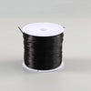 A spool of black flat elastic beading thread for jewelry making