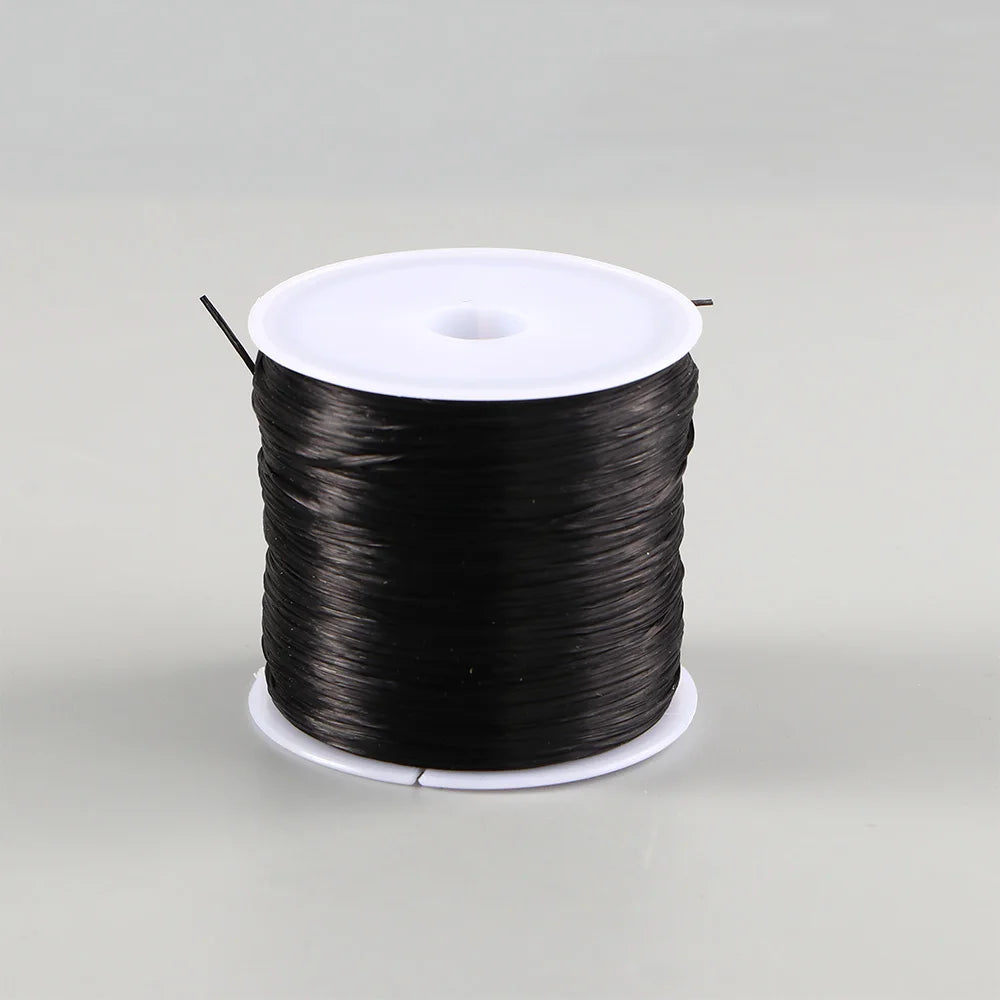 A spool of black flat elastic beading thread for jewelry making
