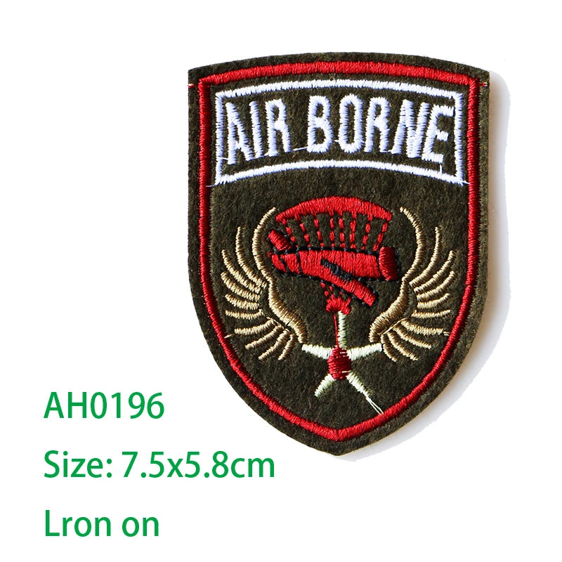 An embroidered iron-on patch featuring the text AIR BORNE and a red emblem on a dark gray background.