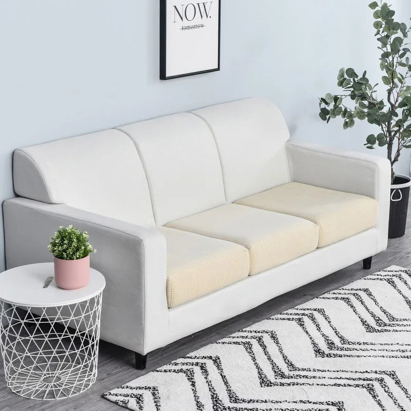 A white sofa with a cream seat cushion cover displayed in a modern living room setting.
