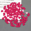 A pile of pink and red felt heart appliques for crafting and decoration.