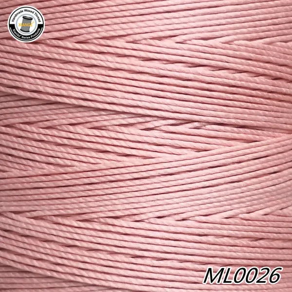 Pink embroidery thread cord in a spool showing the fine texture and strands.