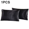 One black silky satin pillowcase shown in a flat lay view.