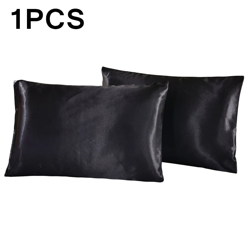 One black silky satin pillowcase shown in a flat lay view.