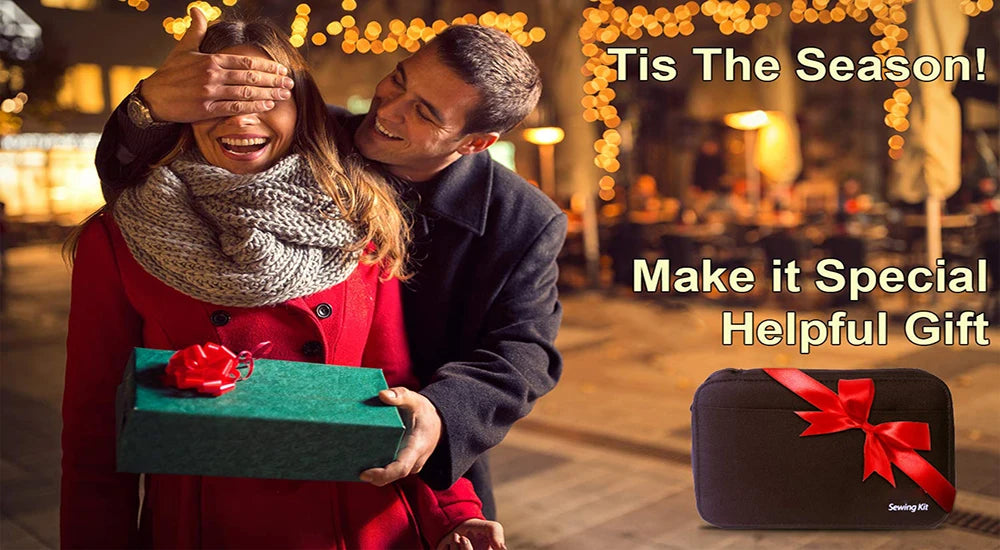 A couple smiling outdoors while holding a green gift box and a black sewing kit.