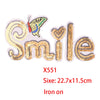 Iron-on patch featuring a smiling butterfly design with gold and pink sequins