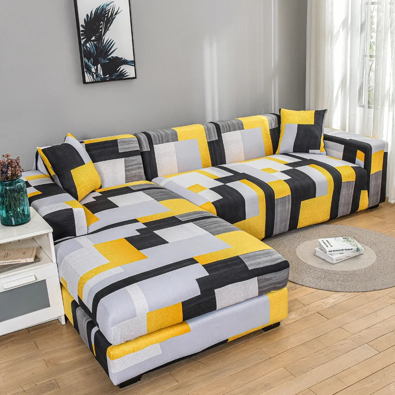 A modern sofa covered with stylish printed protector covers featuring a geometric pattern of black, gray, and yellow squares.
