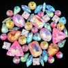 A collection of colorful, faceted gemstone rhinestones in pink, blue, green, and yellow hues.
