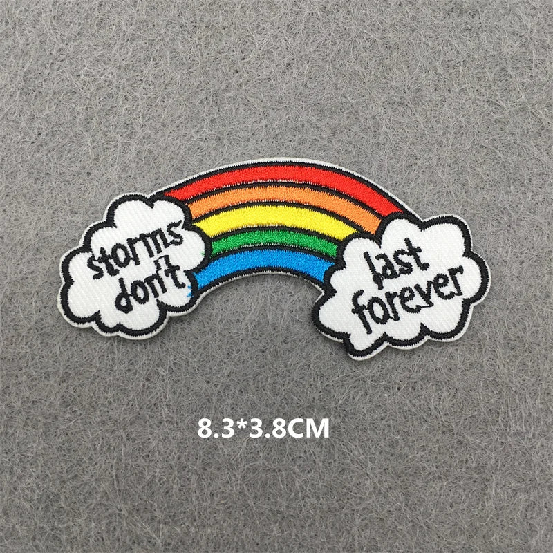 Rainbow embroidered iron-on patch featuring a rainbow arc with the text storms don't last forever