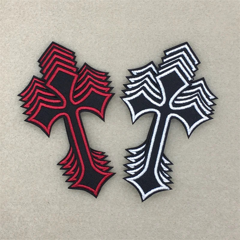 Two embroidered cross applique patches, one black and red striped, the other black and white striped.