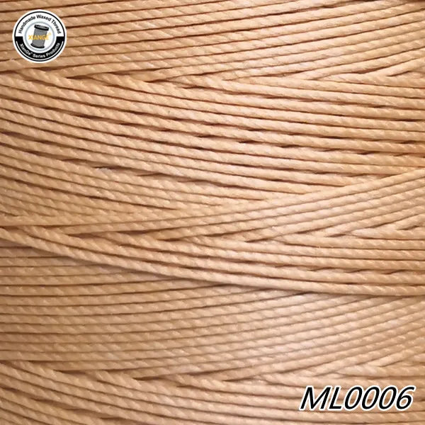 A spool of light brown waxed thread embroidery cord is shown in a close-up view.