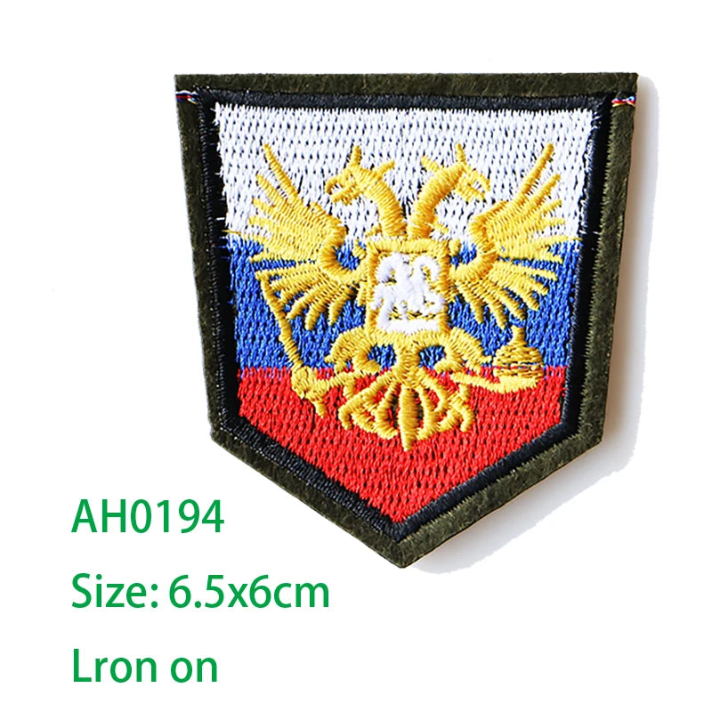 Embroidered iron-on patch featuring a golden eagle on a blue and red background.